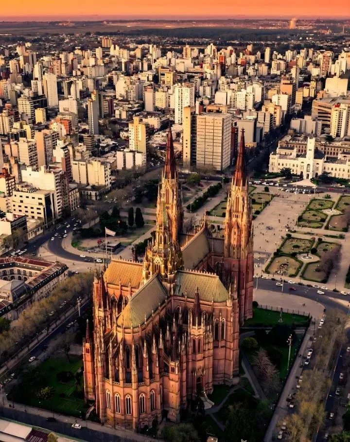 Vista aérea panorâmica da Catedral de La Plata ao pôr do sol, destino final dos alunos da Adelante Assessoria em Medicina.