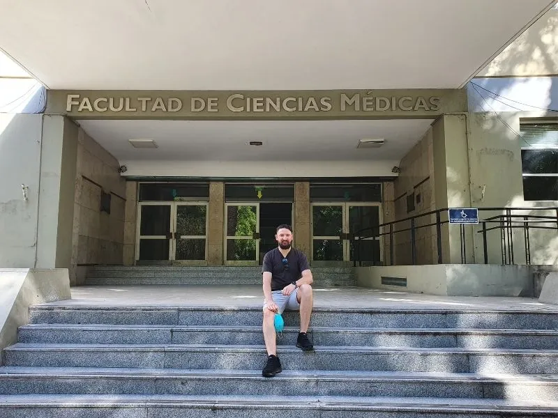 Diego, fundador da Adelante Assessoria, em frente à Faculdade de Ciências Médicas da UNLP em La Plata, garantindo a matrícula presencial dos alunos.